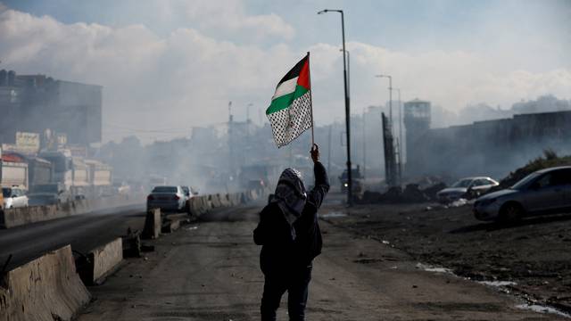 FILE PHOTO: Palestinians clash with Israeli forces near Qalandia