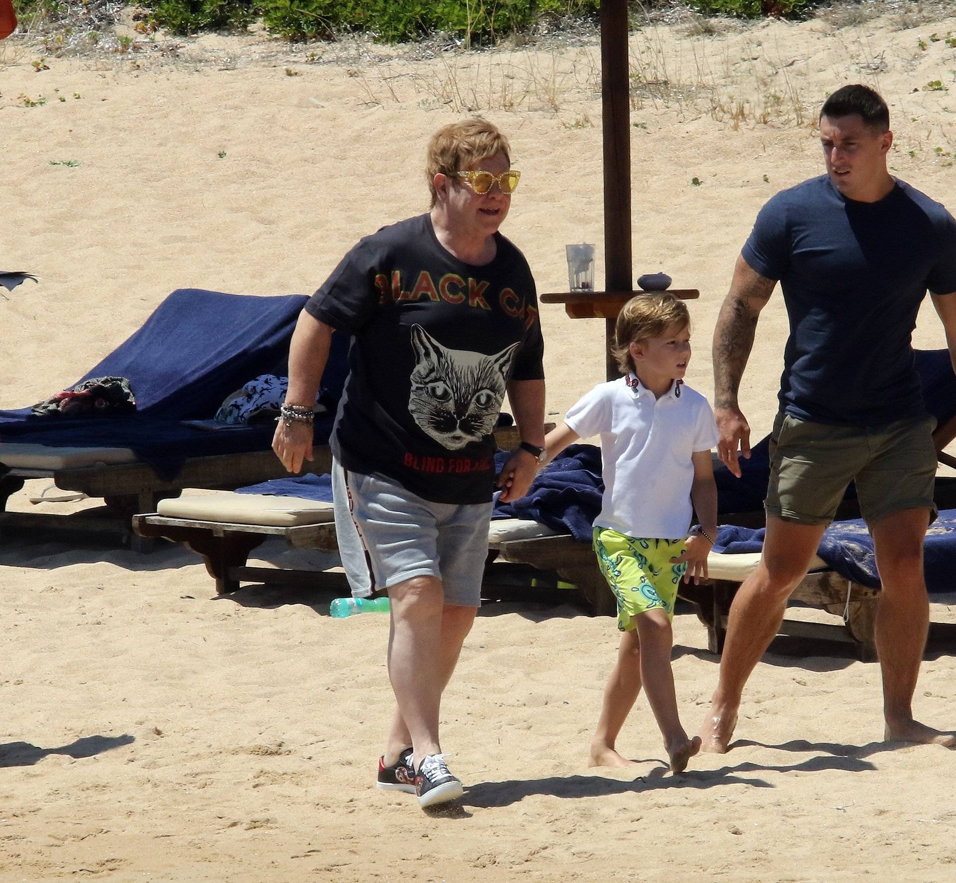 Elton John and David Furnish reaching the beach with kids