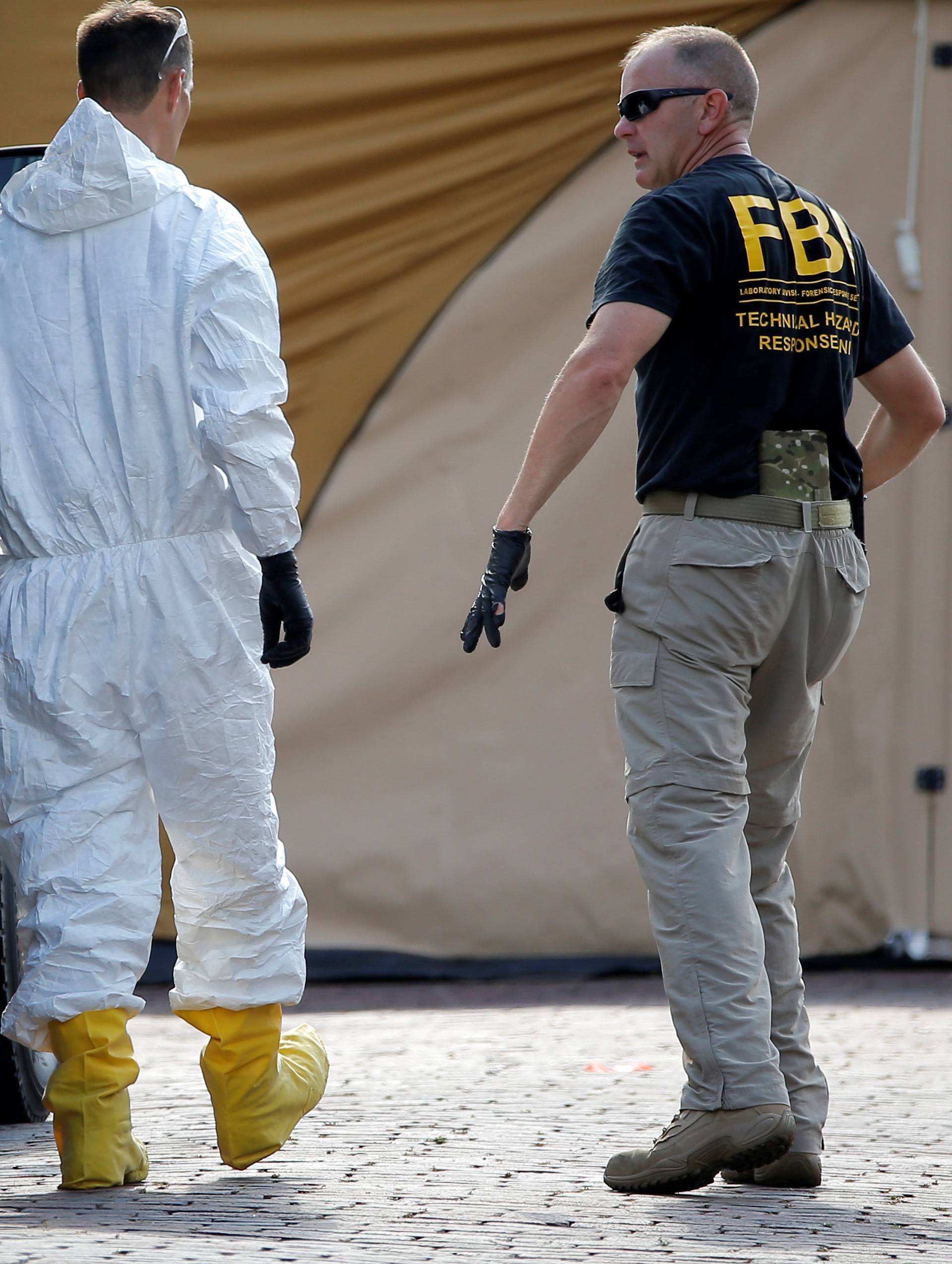 Police forensic investigators work at the crime scene of a mass shooting at the Pulse gay night club in Orlando