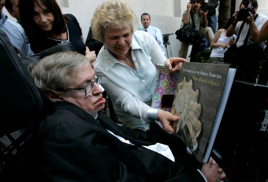 FILE PHOTO: British physicist Hawking looks at book of Chile's Nobel Laureate Neruda after meeting Chile's President Bachelet in Santiago