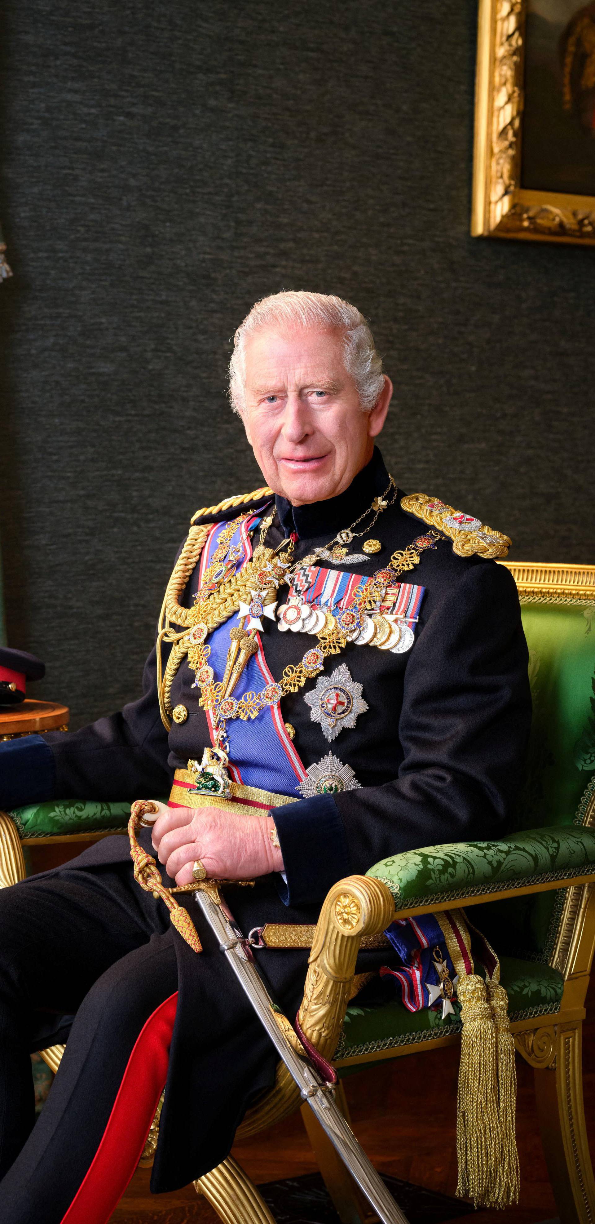 Britain's King Charles poses for a picture while wearing his Field Marshal No1 Full Ceremonial Frock Coat with medals, sword and decorations, in this undated handout picture