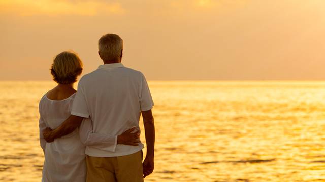 Panorama,Senior,Man,And,Woman,Couple,Embracing,At,Sunset,Or