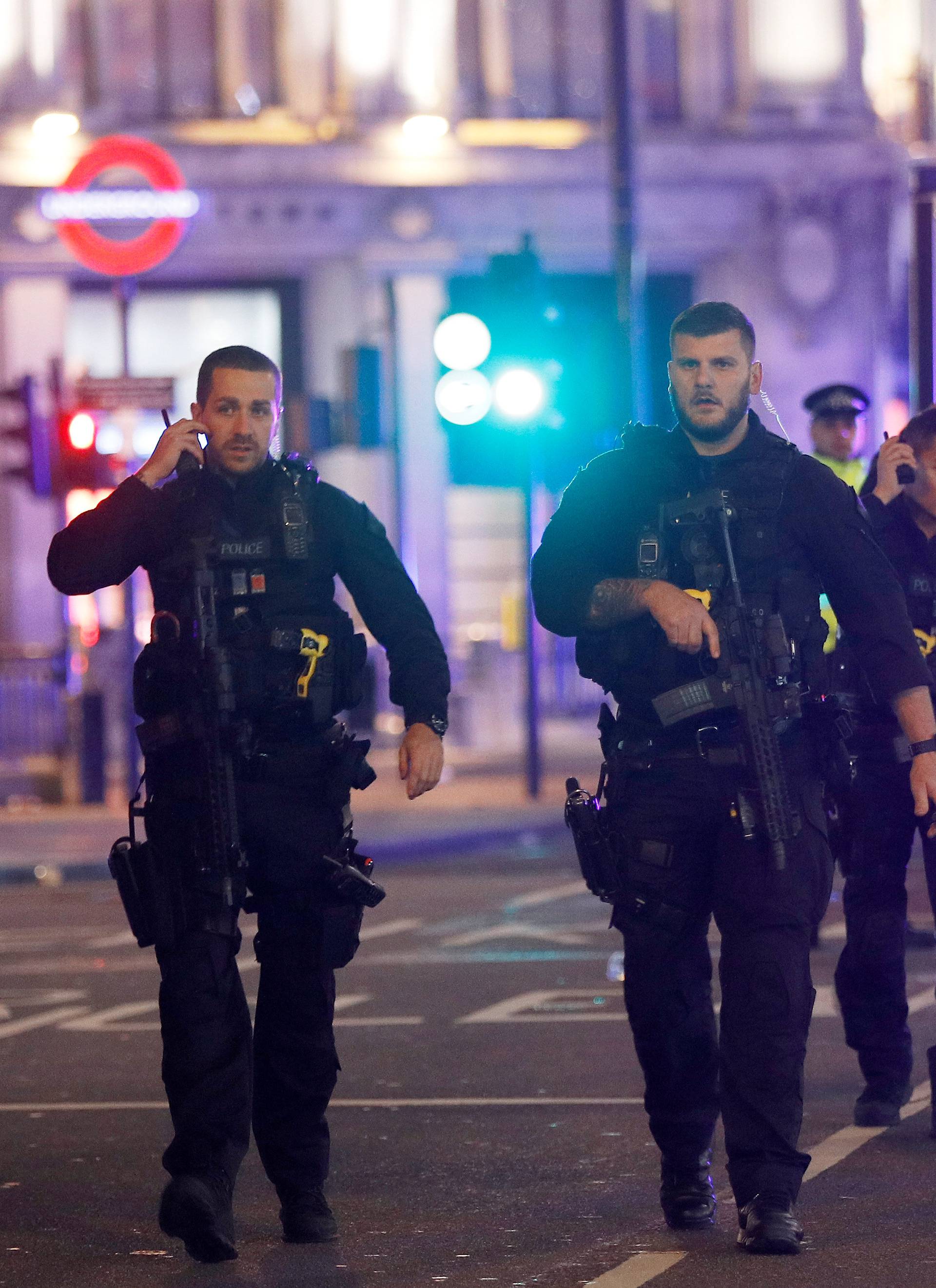 Armed police officers walk along Oxford Street, London