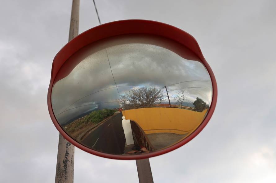 Mirror reflects smoke rising following the eruption of a volcano on the Island of La Palma