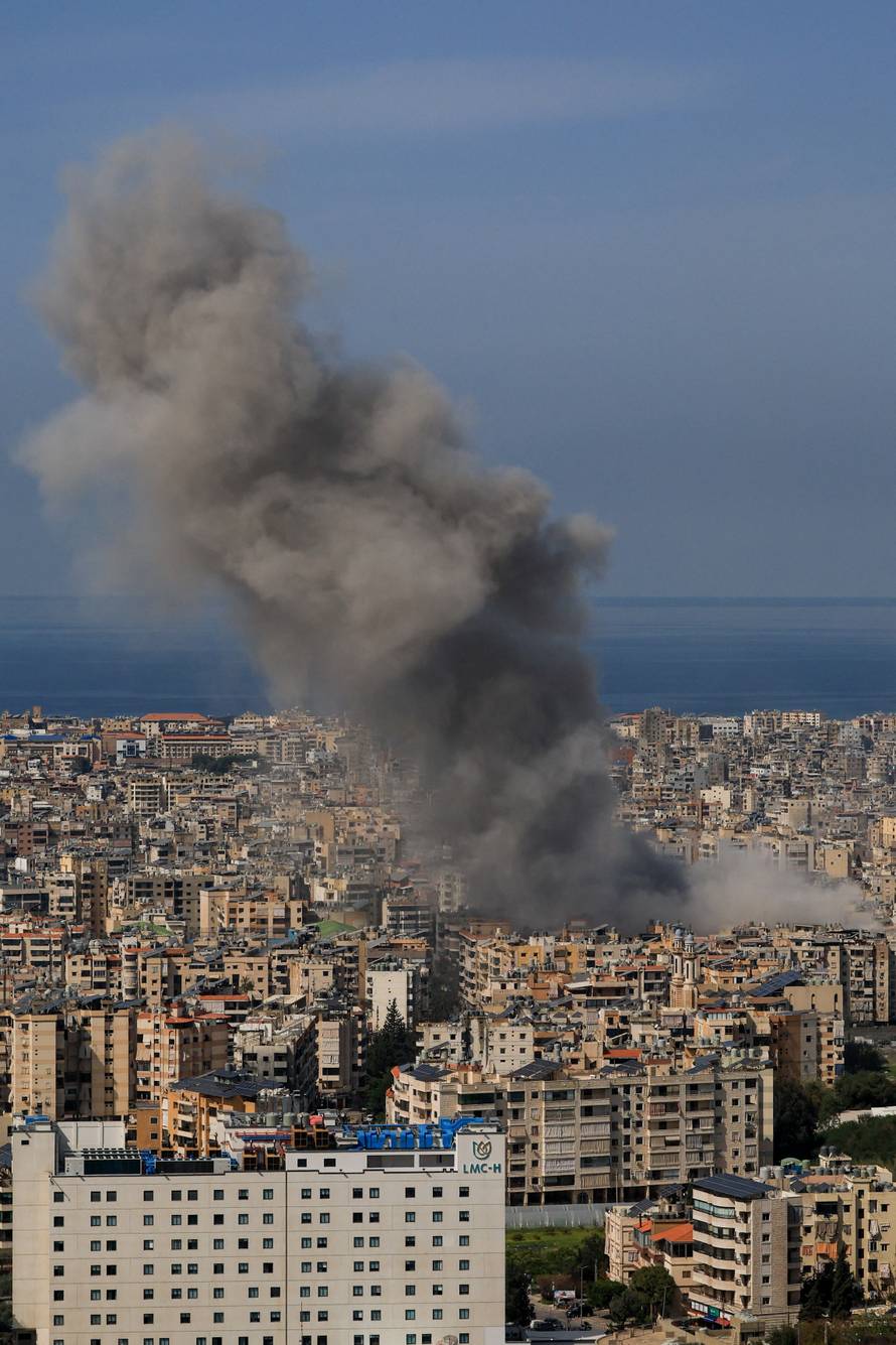 Smoke billows after reported strikes on Beirut’s southern suburbs, as seen from Baabda
