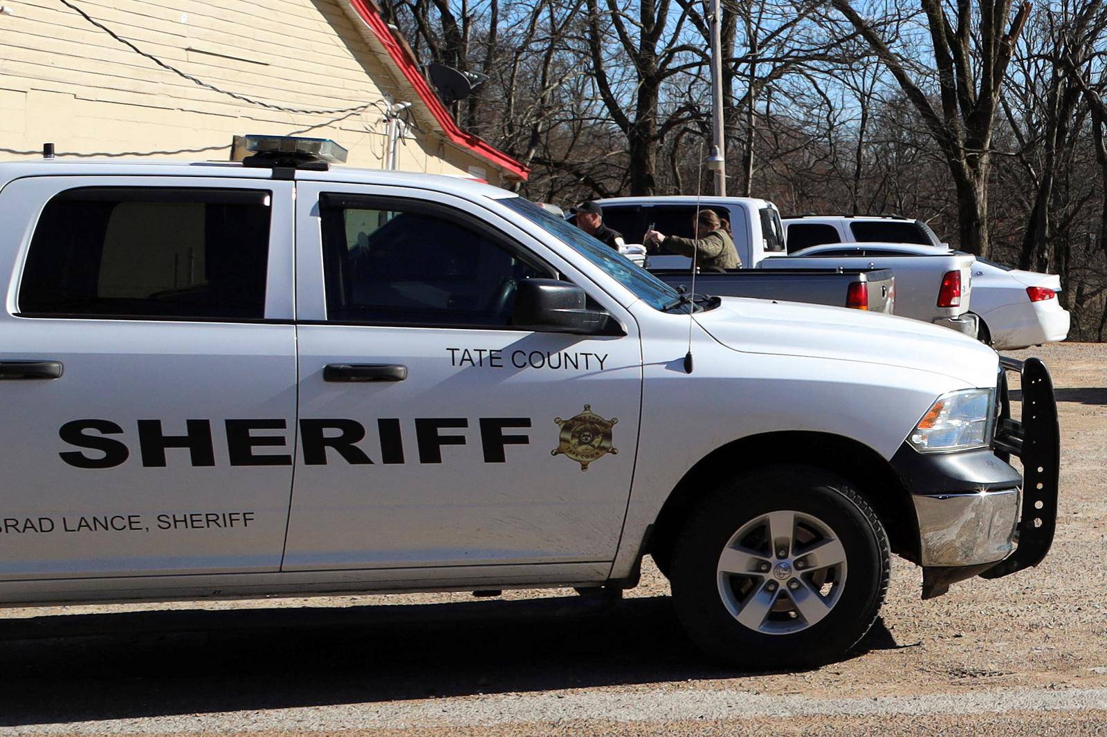 A vehicle of the Tate County Sheriff is seen parked outside a gas station convenience store after a shooting, in Arkabutla