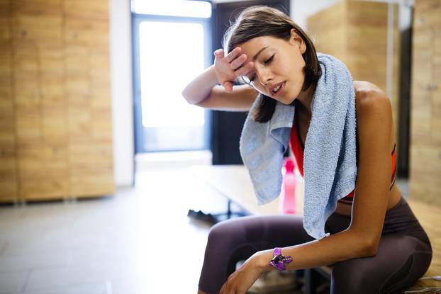 Disappointed tired woman trying to reach fitness goals by endurance and stamina training