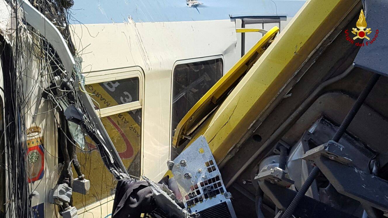 Two passenger trains are seen after a collision in the middle of an olive grove in the southern village of Corato