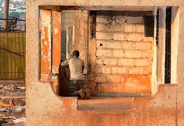 FILE PHOTO: A Malian soldier stands in position with his weapon during an attack on Mali's main military base Kati outside the capital Bamako