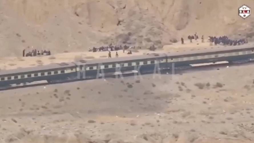 People gather outside a train during an attack by separatist militants near Mashkaf