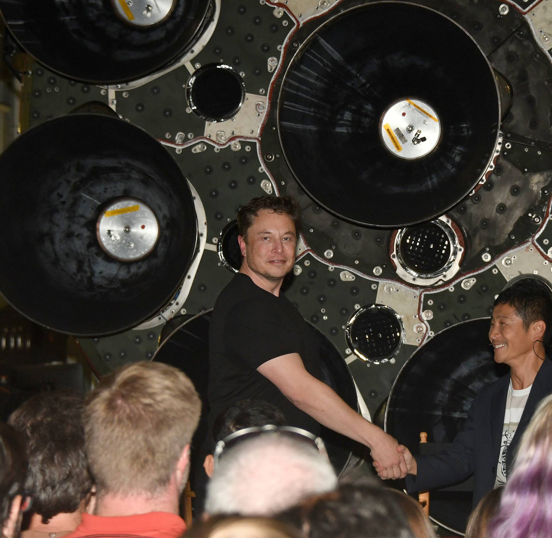 SpaceX CEO Elon Musk shakes hands with Japanese billionaire Yusaku Maezawa during a press conference about being the first SpaceX private passenger to circle the moon aboard SpaceXâs BFR launch vehicle, at the company's headquarters in Hawthorne