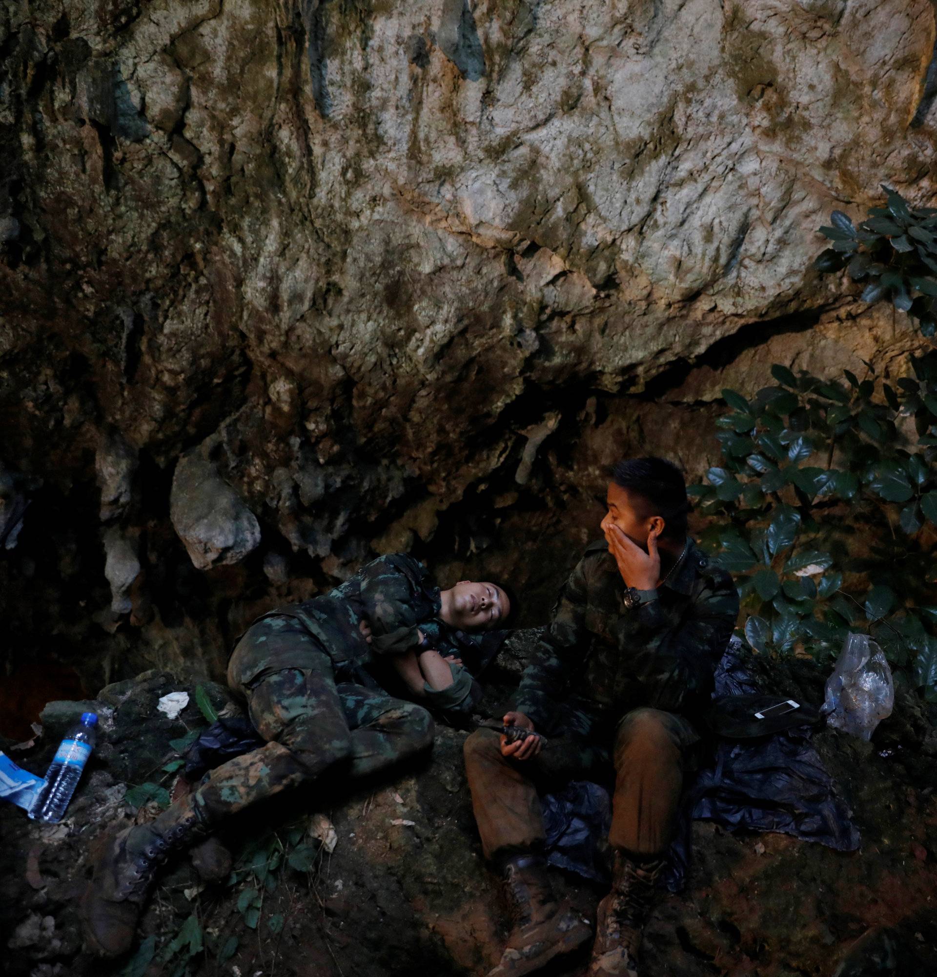 Soldiers take a rest in Tham Luang caves during a search for 12 members of an under-16 soccer team and their coach, in the northern province of Chiang Rai