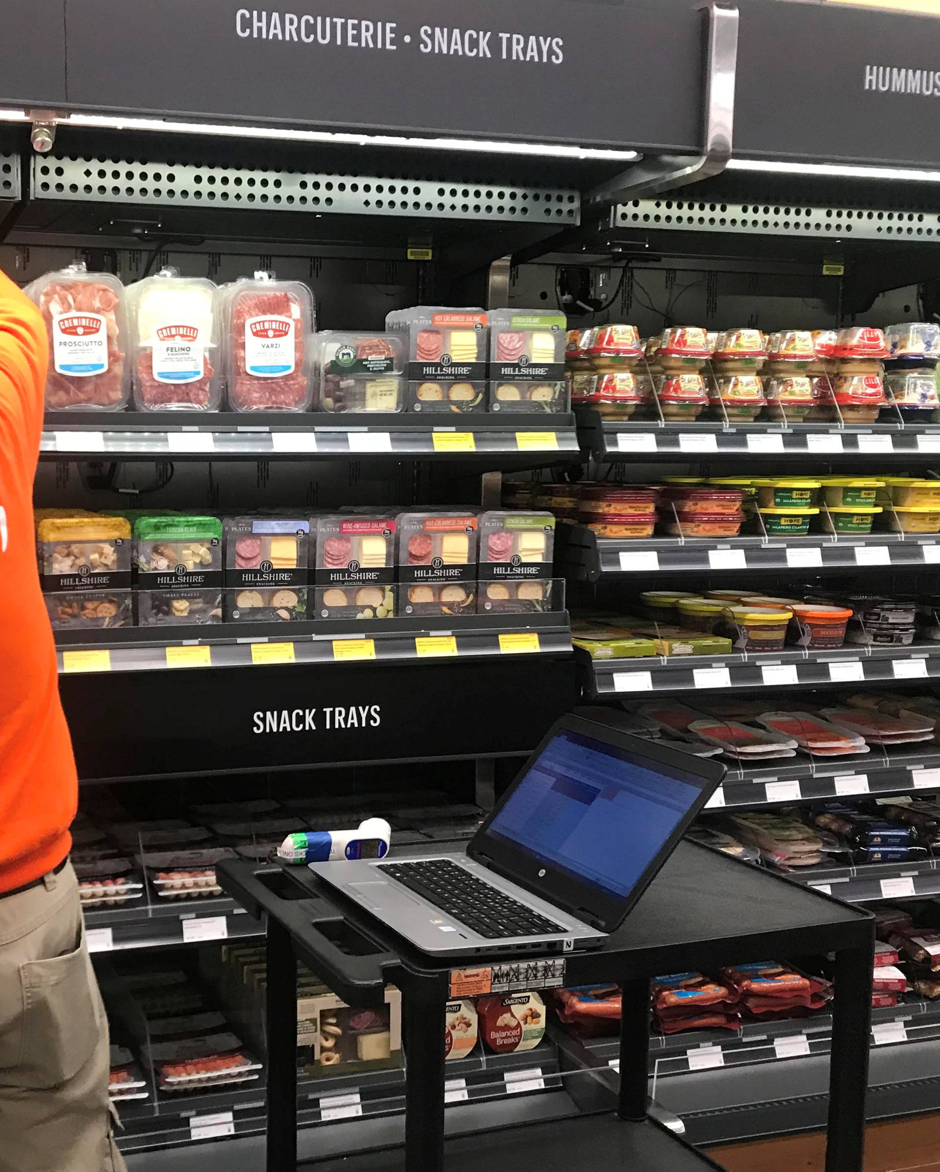 An Amazon employee manages inventory in the company's line-free Seattle store days before the store's public debut, in Seattle