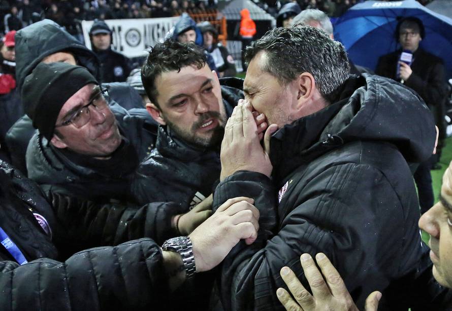 Olympiacos coach Oscar Garcia reacts after his injury during a Greek Super League soccer match between PAOK and Olympiacos in Thessaloniki