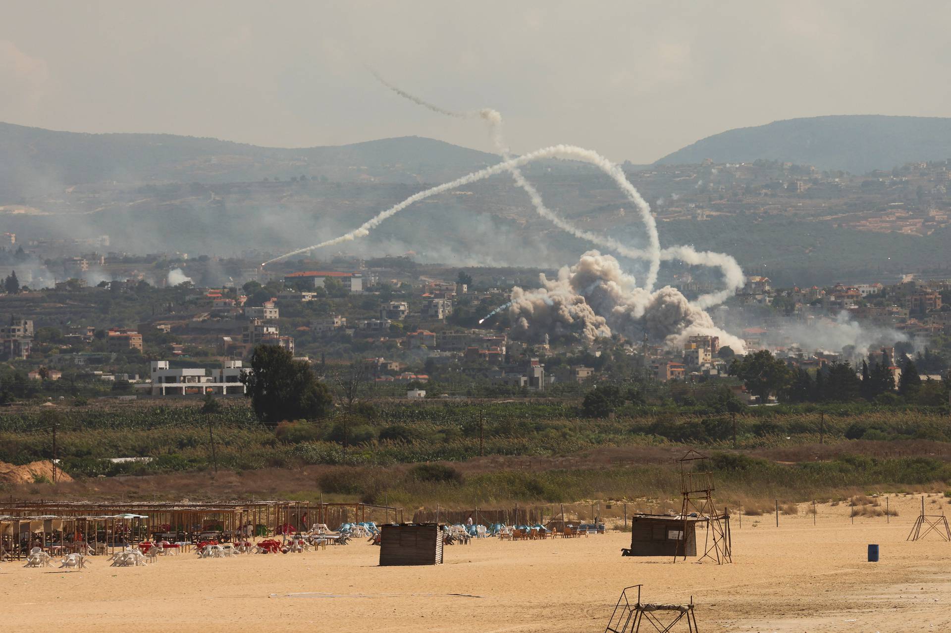 Smoke billows over southern Lebanon following Israeli strikes, as seen from Tyre, southern Lebanon