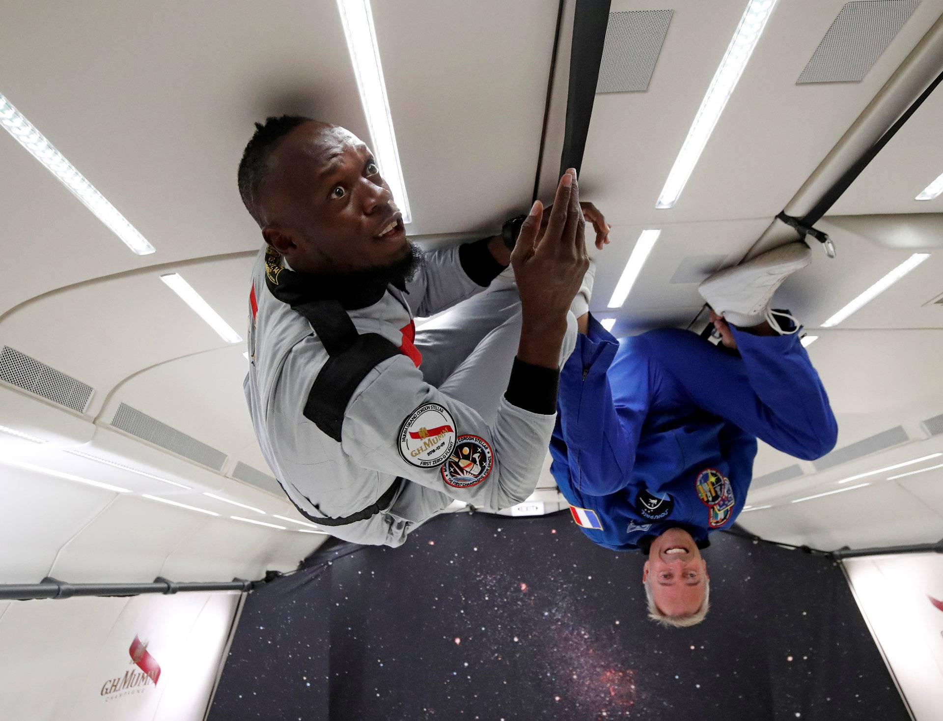 Retired sprinter Usain Bolt and French astronaut Jean-Francois Clervoy enjoy zero gravity conditions during a flight in a specially modified plane above Reims