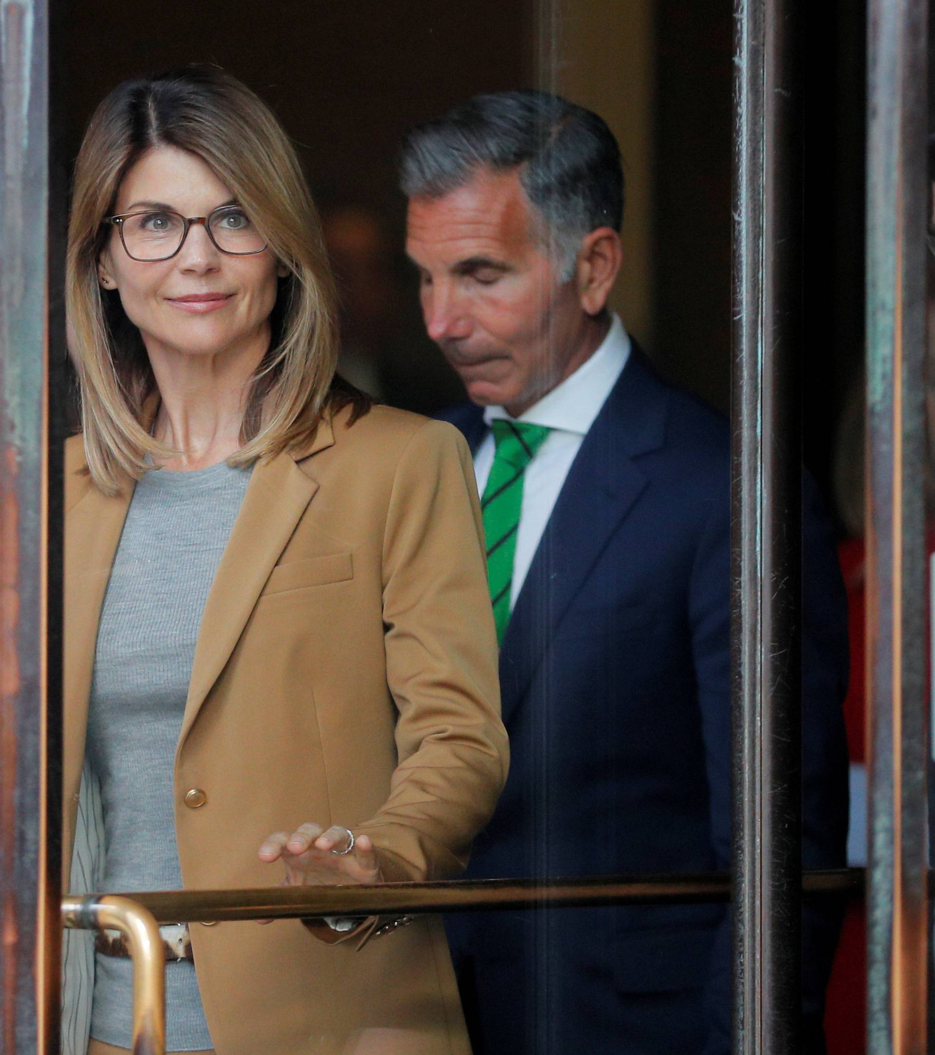 FILE PHOTO: Actor Lori Loughlin, and husband, fashion designer Mossimo Giannulli, facing charges in a nationwide college admissions cheating scheme, leave federal court in Boston