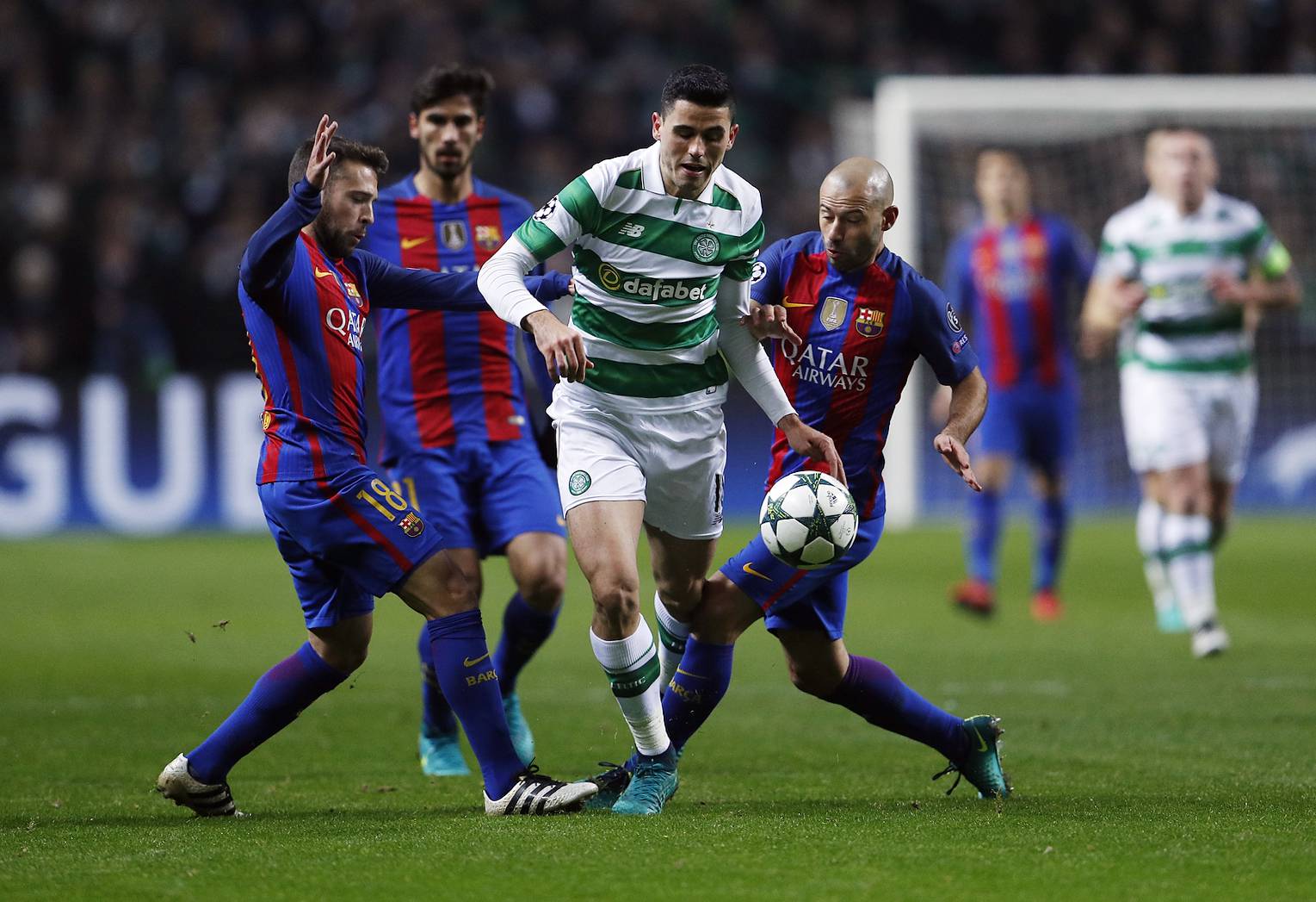Celtic's Stuart Armstrong in action with Barcelona's Jordi Alba and Javier Mascherano (R)