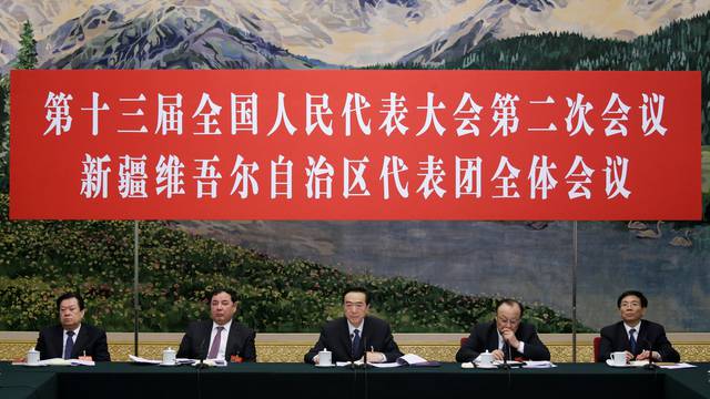 Officials attend the meeting of Xinjiang delegation on the sidelines of the National People's Congress (NPC), at the Great Hall of the People in Beijing