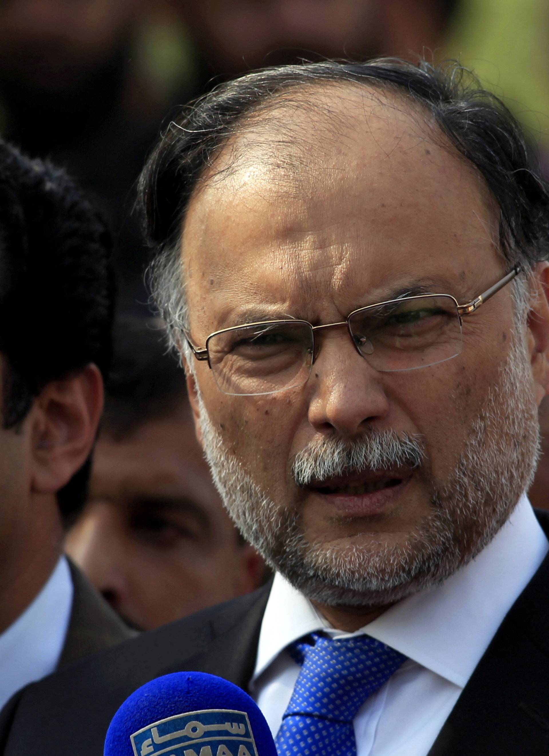 FILE PHOTO: Pakistan's Interior Minister Ahsan Iqbal speaks to media outside the accountability court in Islamabad