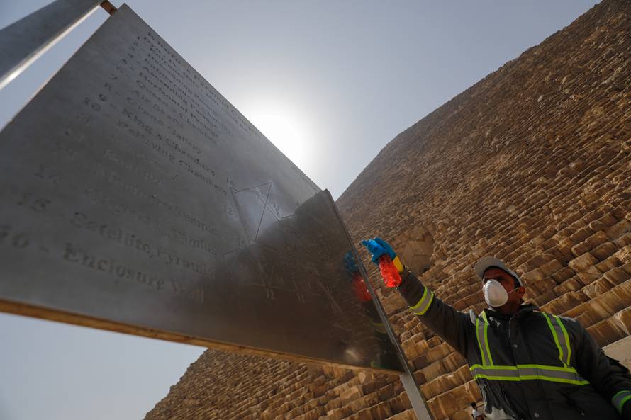 A member of the medical team sprays disinfectant as a precautionary move amid concerns over the coronavirus disease (COVID-19) outbreak at the Great Pyramids, Giza, on the outskirts of Cairo