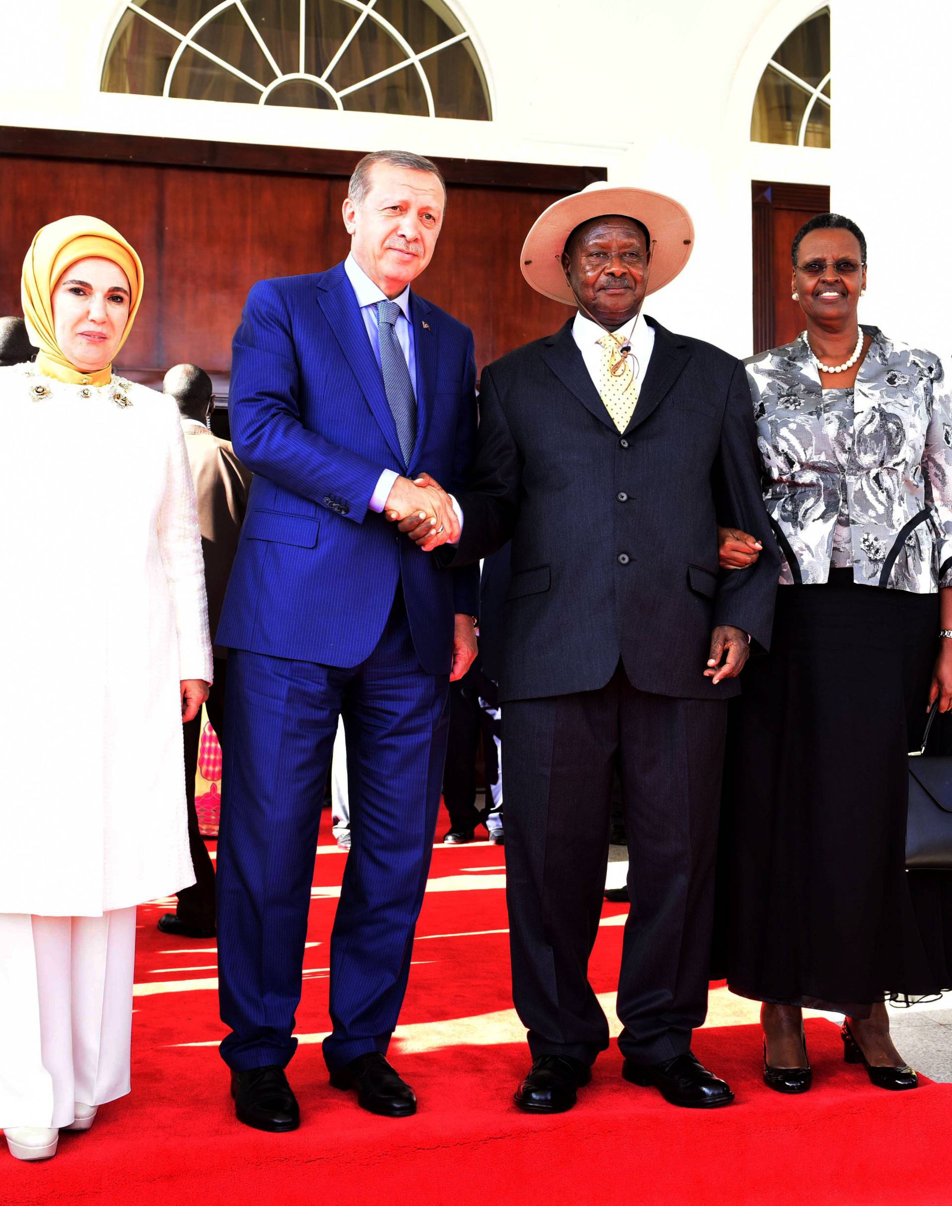 Turkish President Erdogan poses for a photograph with Uganda's President Museveni after a joint news conference at the State House in Entebbe