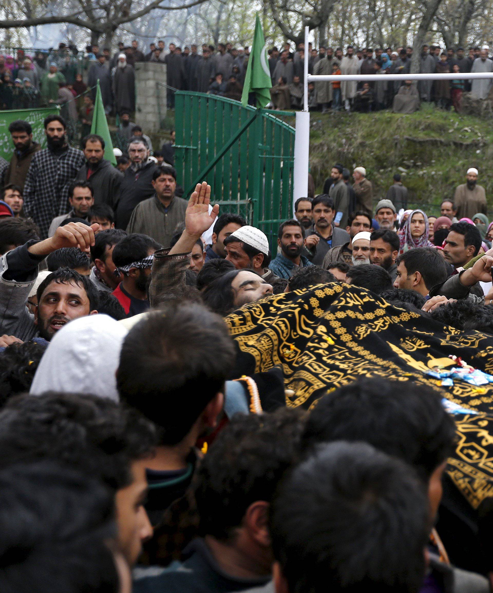 Kashmiri Muslims carry the body of Bilal Ahamd, a suspected militant, during his funeral in Karimabad 