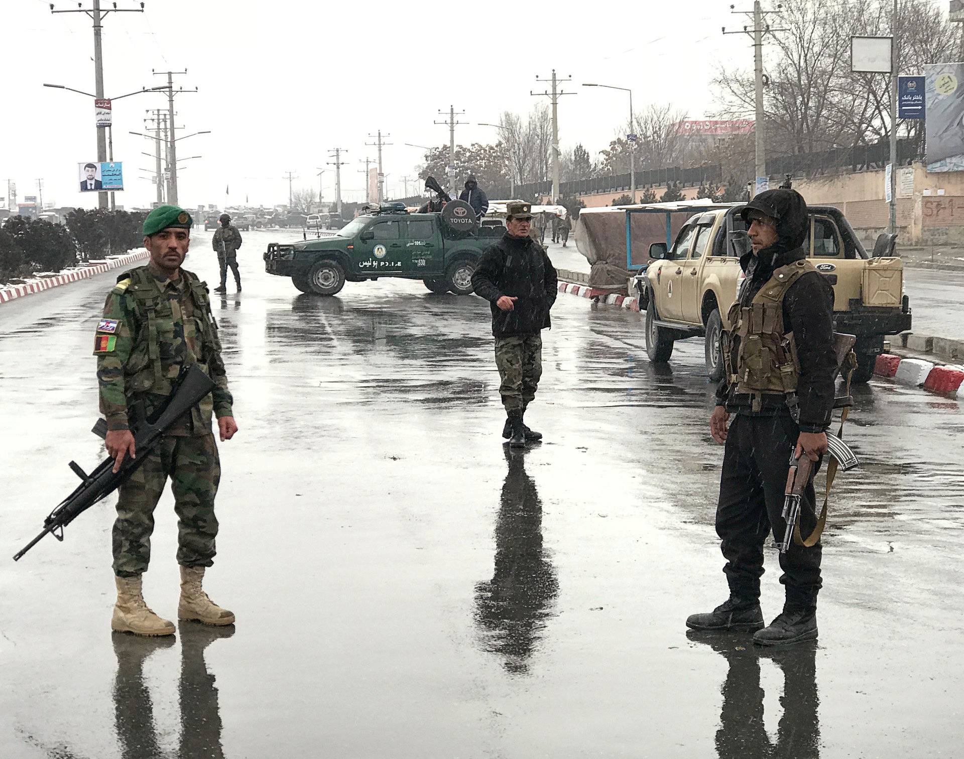 Afghan security forces stand near the Marshal Fahim military academy after a series of explosions in Kabul