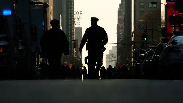 A police officer walks down the street outside the New York Port Authority Bus Terminal in New York City after reports of an explosion.
