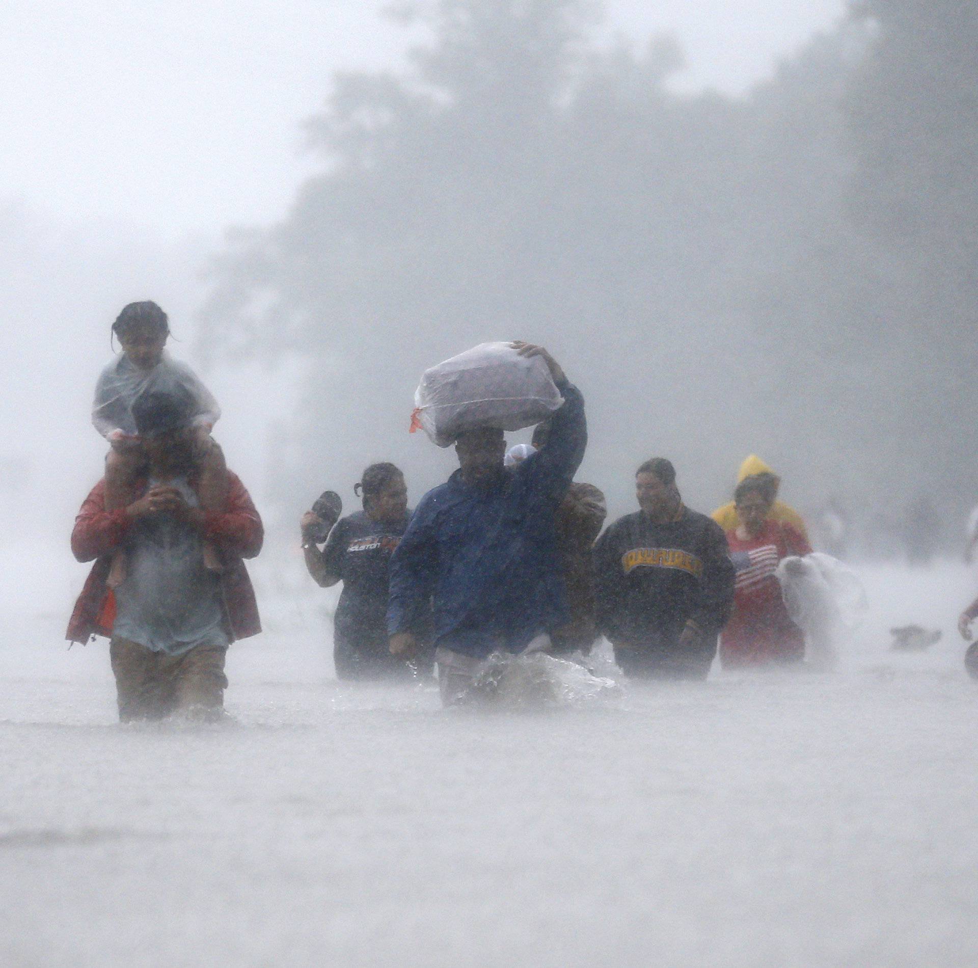 Residents wade through flood waters from Tropical Storm Harvey in Beaumont Place, Houston