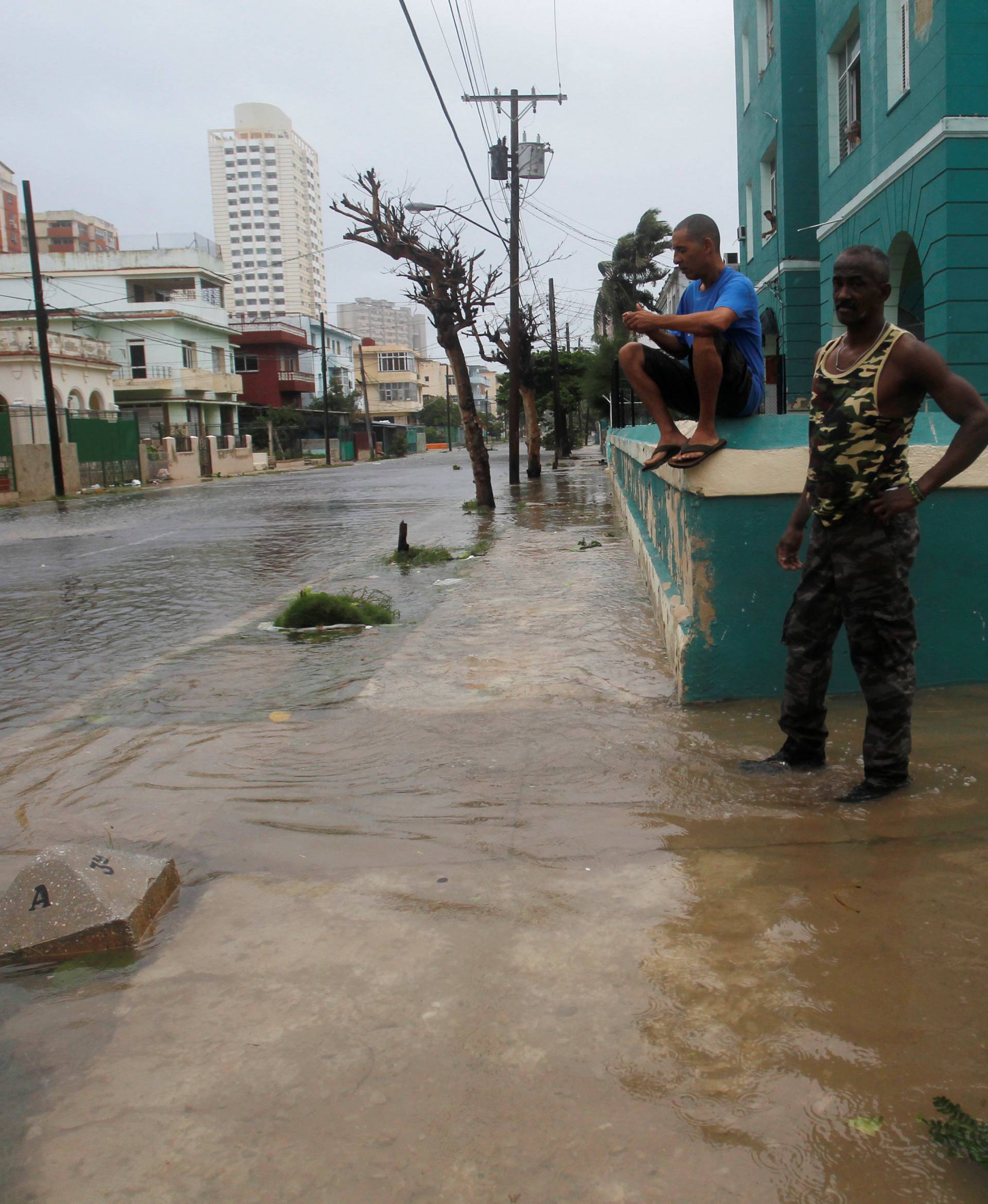 People are seen on a flooded street as Hurricane Irma turns toward the Florida Keys on Saturday, in Havana