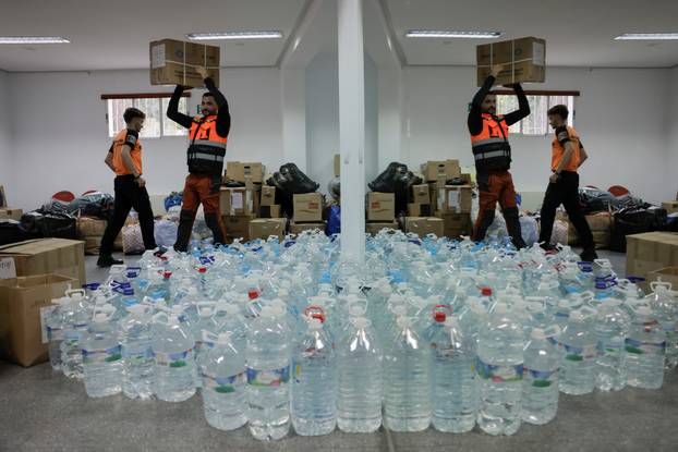 Members of Civil Protection prepare donations to be sent by truck to victims of flooding in Valencia, in Ronda