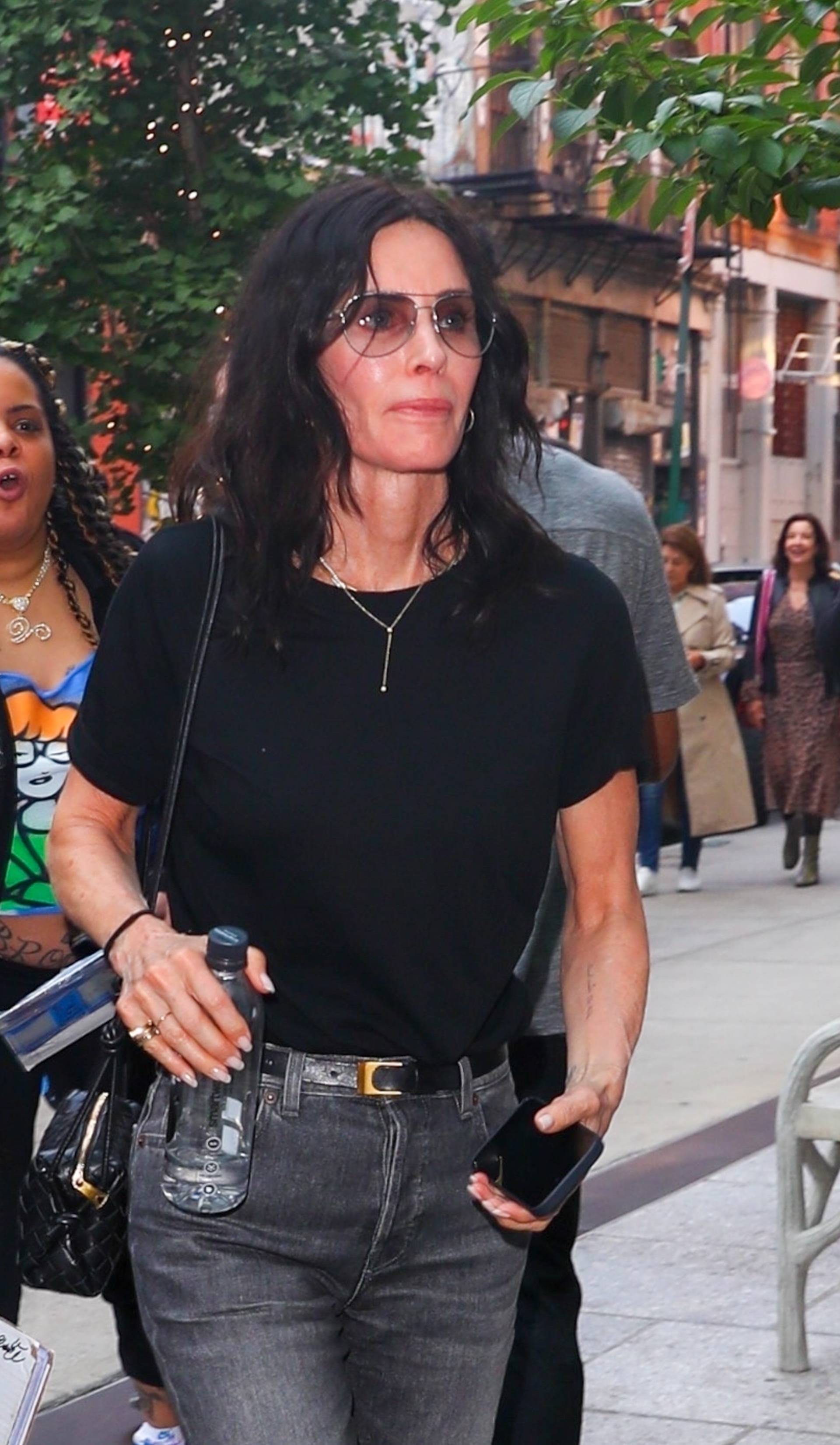 Courtney Cox greets fans while returning to her hotel this afternoon in SOHO