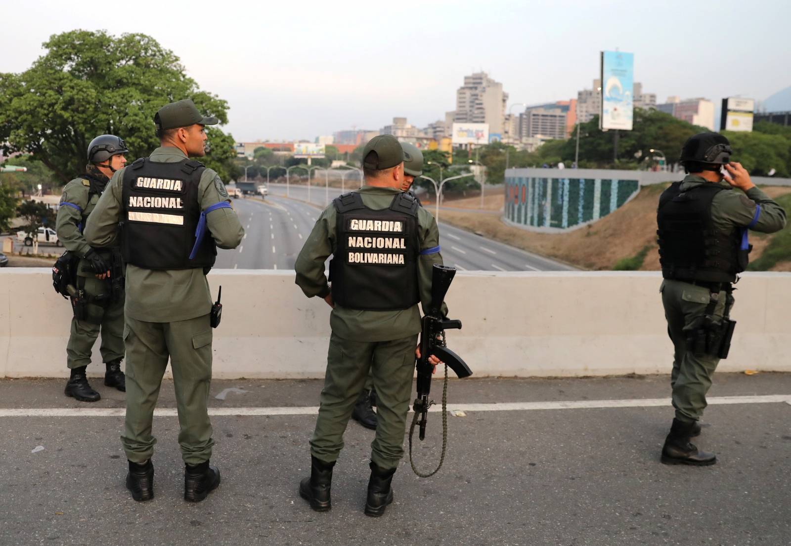 Military members stand near the Generalisimo Francisco de Miranda Airbase in Caracas