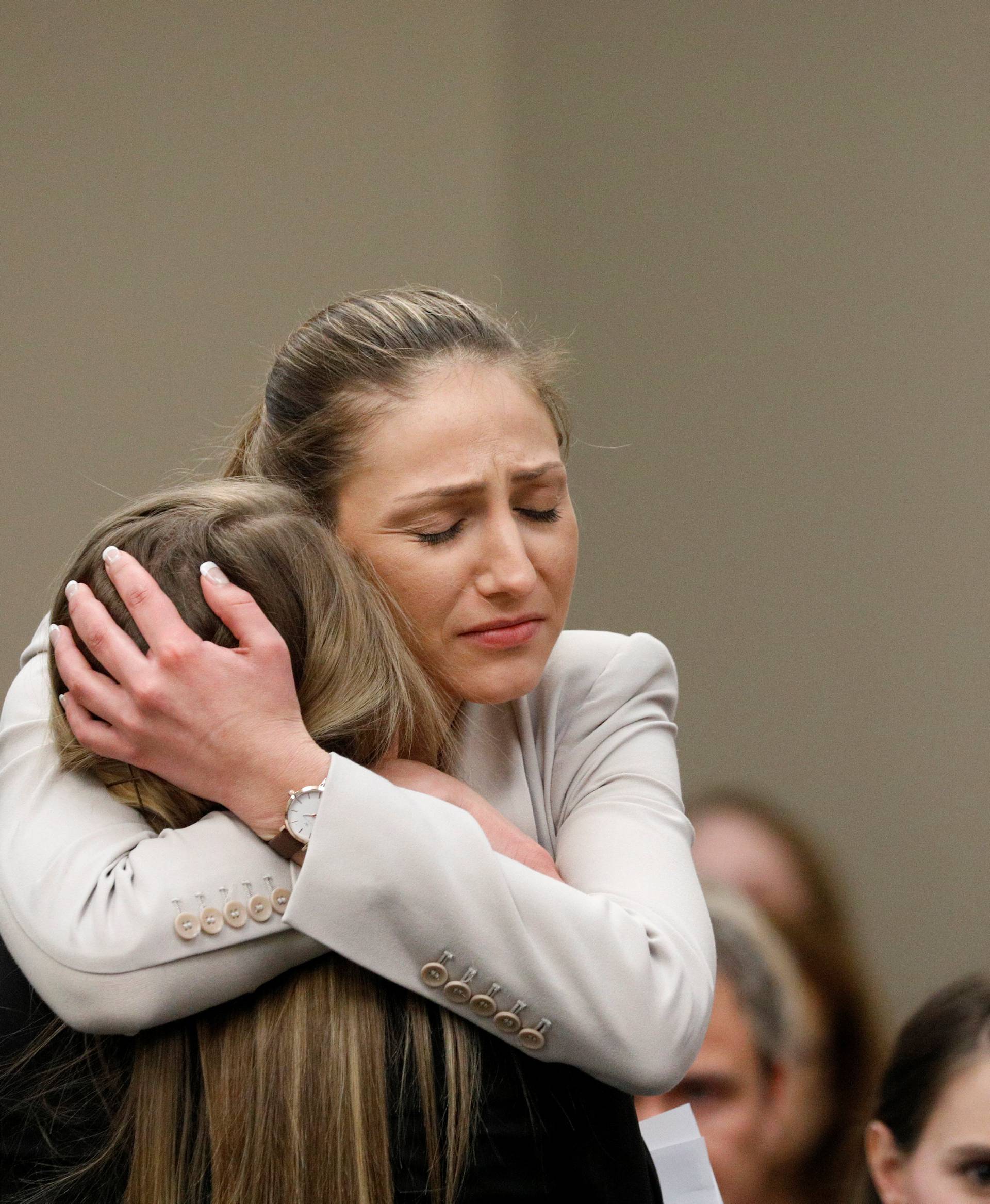 Victim Emily Morales is hugged after speaking at the sentencing hearing for Larry Nassar, a former team USA Gymnastics doctor who pleaded guilty in November 2017 to sexual assault charges, in Lansing, Michigan