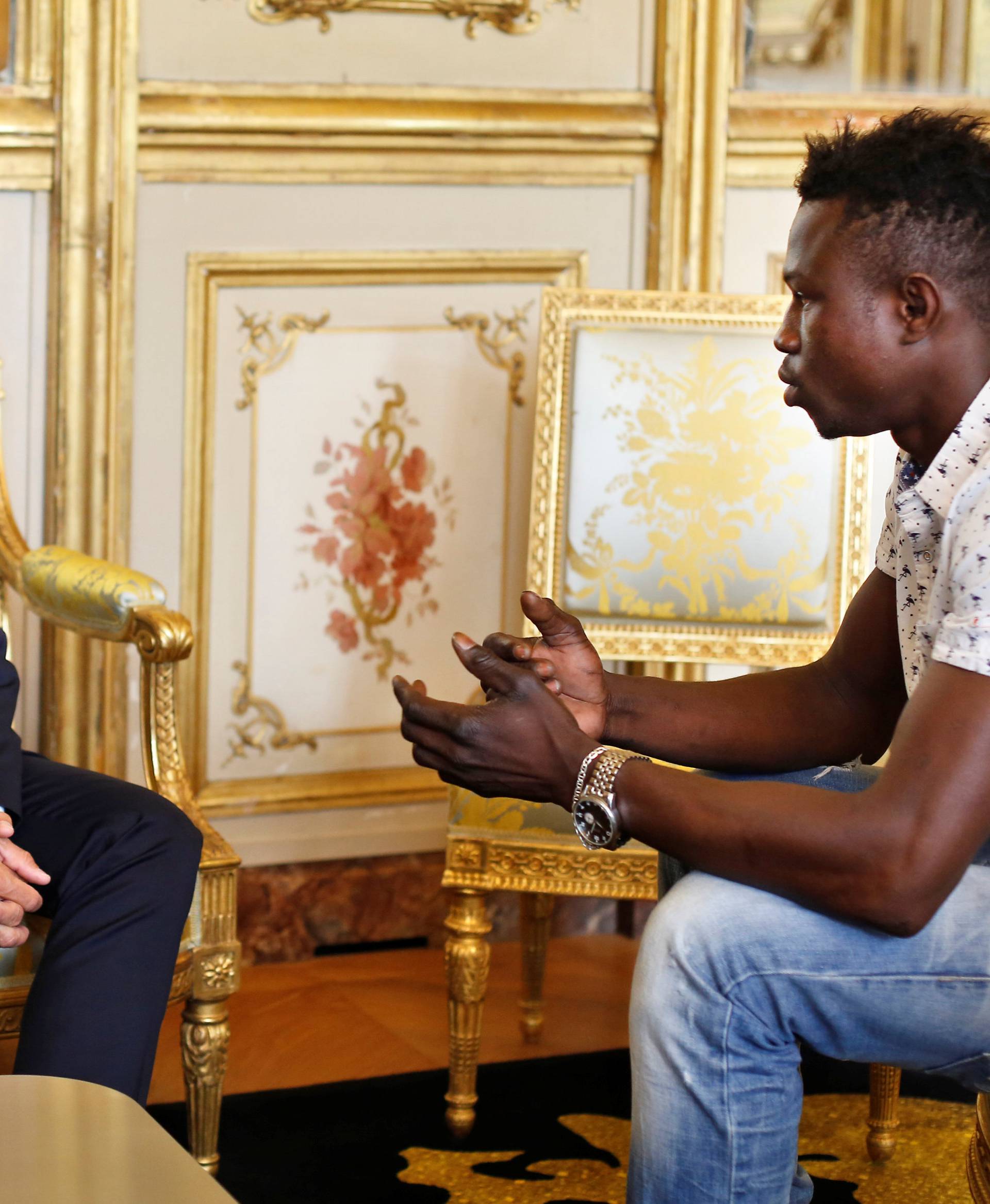 French President Emmanuel Macron meets with Mamoudou Gassama, 22, from Mali, at the Elysee Palace in Paris