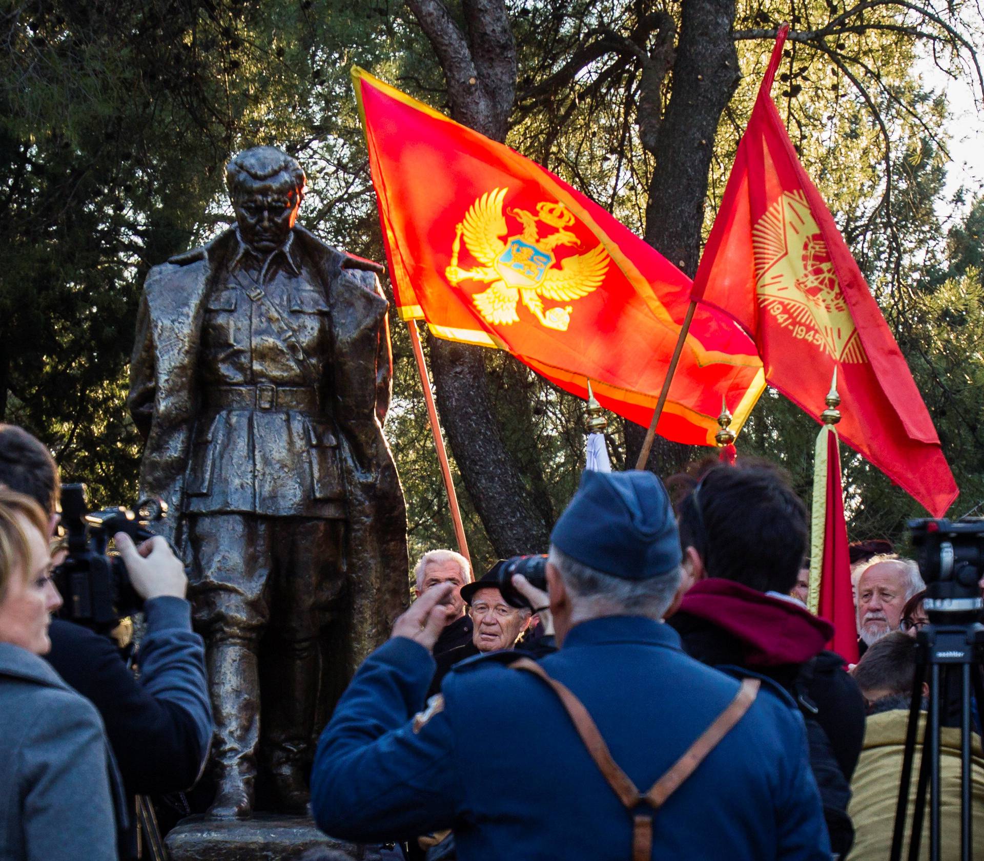 A man wearing old army uniform salutes to the monument of late Yugoslav leader Josip Broz Tito after unveiling ceremony in Podgorica