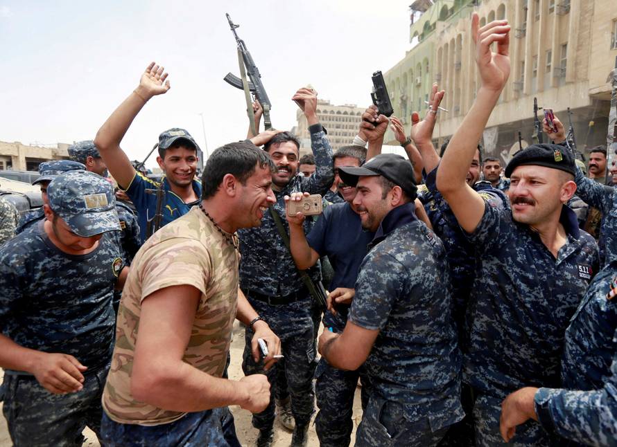Iraqi Federal police celebrate in the Old City of Mosul