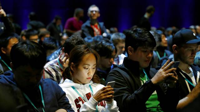 Attendees work on their devices before Apple Inc.'s 2016 Worldwide Developers Conference in San Francisco, California