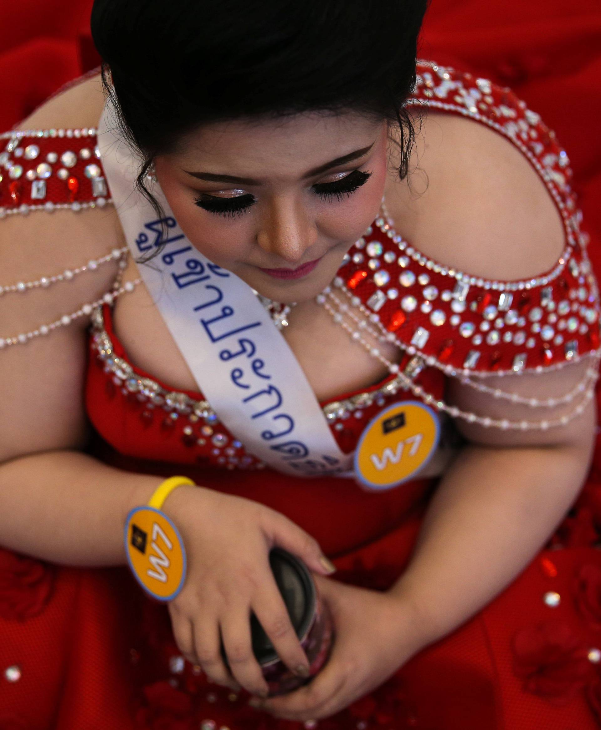 A participant prepares backstage before the final show of the Miss Jumbo 2018 at a department store in Nakhon Ratchasima