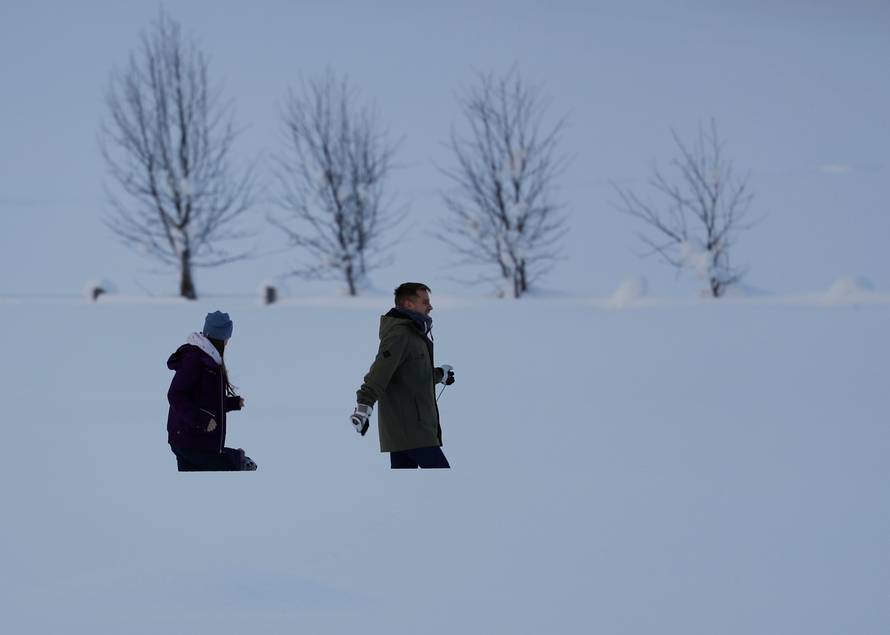 People walk after heavy snowfall in Flachau