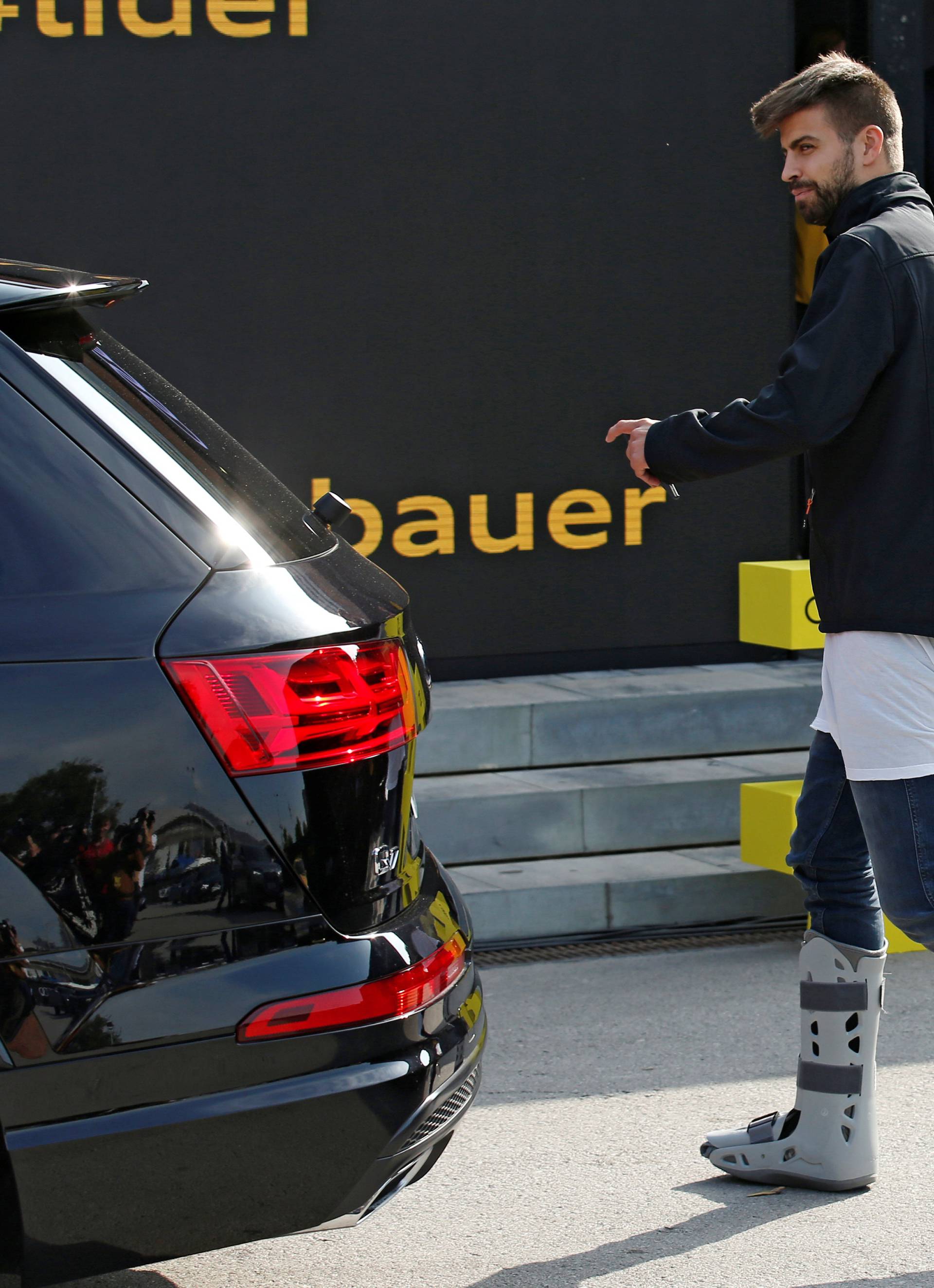 Barcelona's injured soccer player Pique takes part in a commercial event near Camp Nou stadium in Barcelona