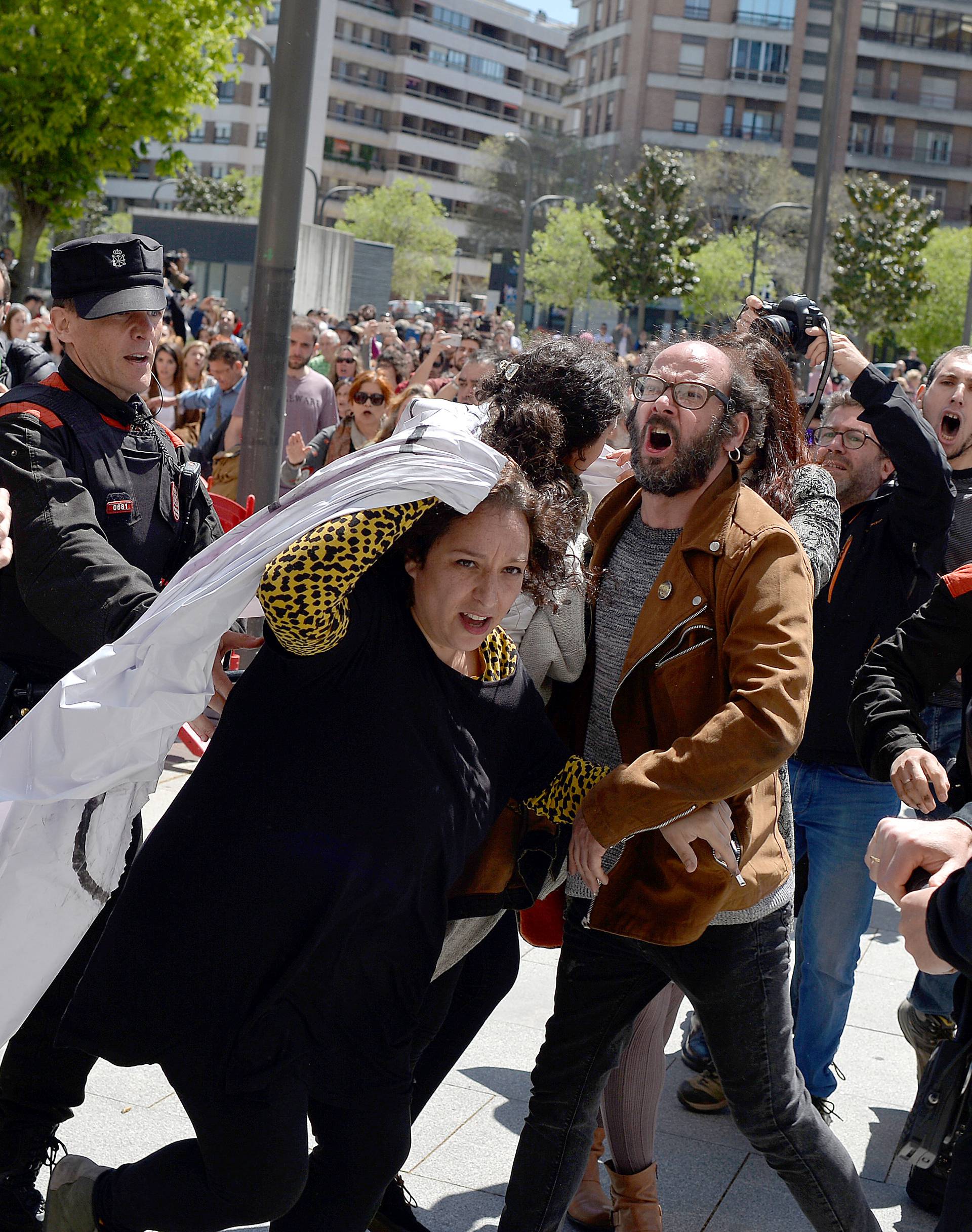 Protesters break through a police line after a nine-year prison sentence was given to five men accused of the multiple rape of a woman during Pamplona's San Fermin festival in 2016, in Pamplona