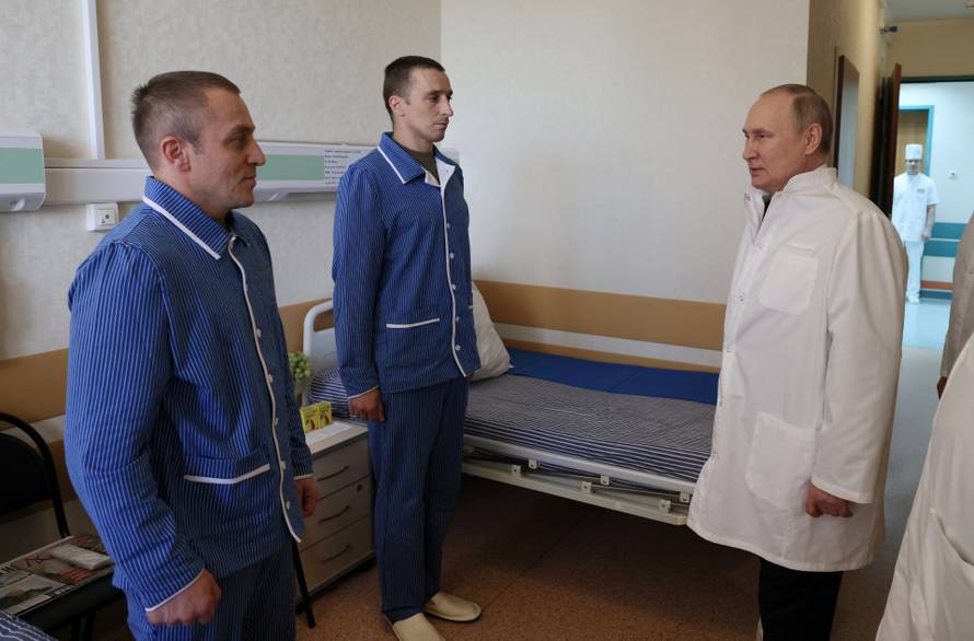 Russian President Vladimir Putin visits soldiers wounded during the conflict in Ukraine at a hospital in Moscow