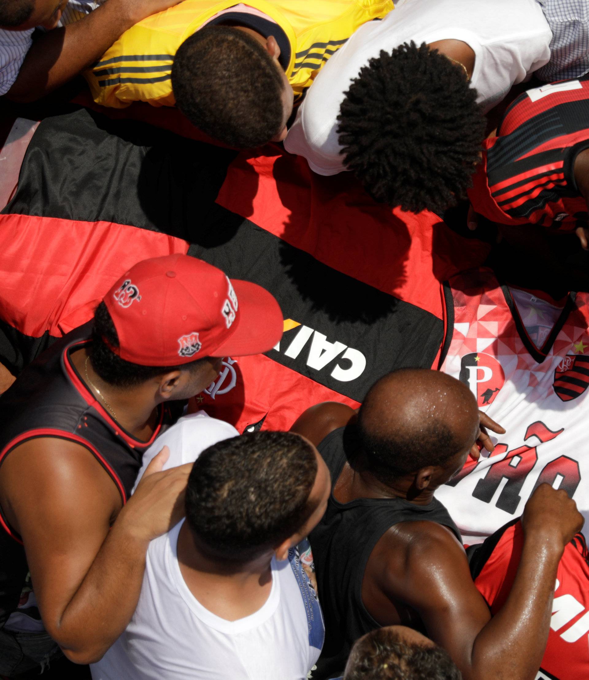 Relatives and friends of goalkeeper Christian Esmerio, 15, react during his burial after a deadly fire at Flamengo soccer club's training center, in Rio de Janeiro