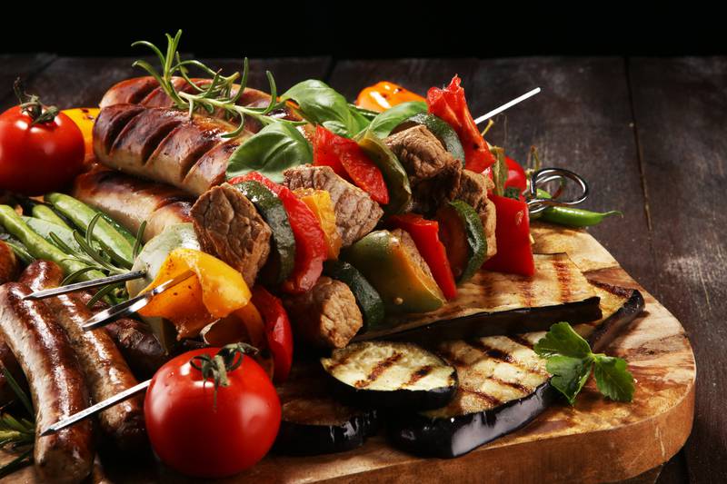 Assorted delicious grilled meat with vegetable  and pork shish or kebab on skewers with vegetables . Food background shashlik