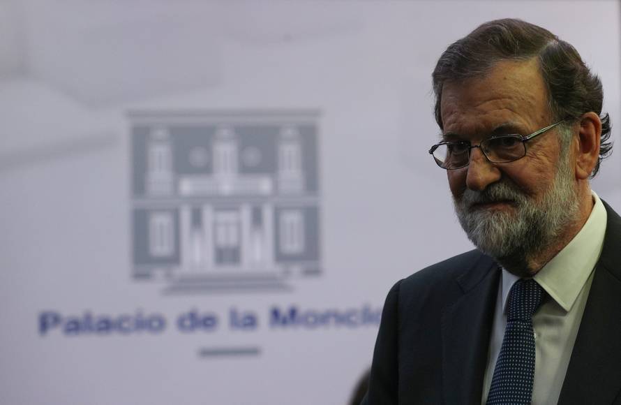 Spain's PM Rajoy leaves the conference room after delivering a statement at the Moncloa Palace in Madrid