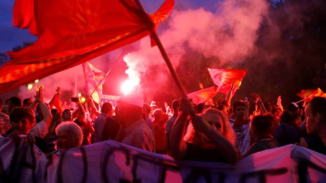 Protestors shout slogans against the change of the country's constitutional name in front of the Parliament building in Skopje