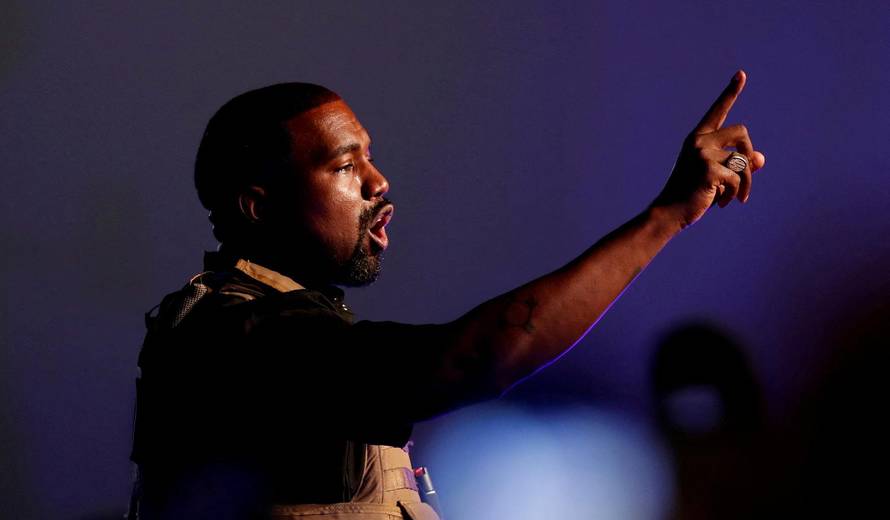 FILE PHOTO: Rapper Kanye West gestures to the crowd