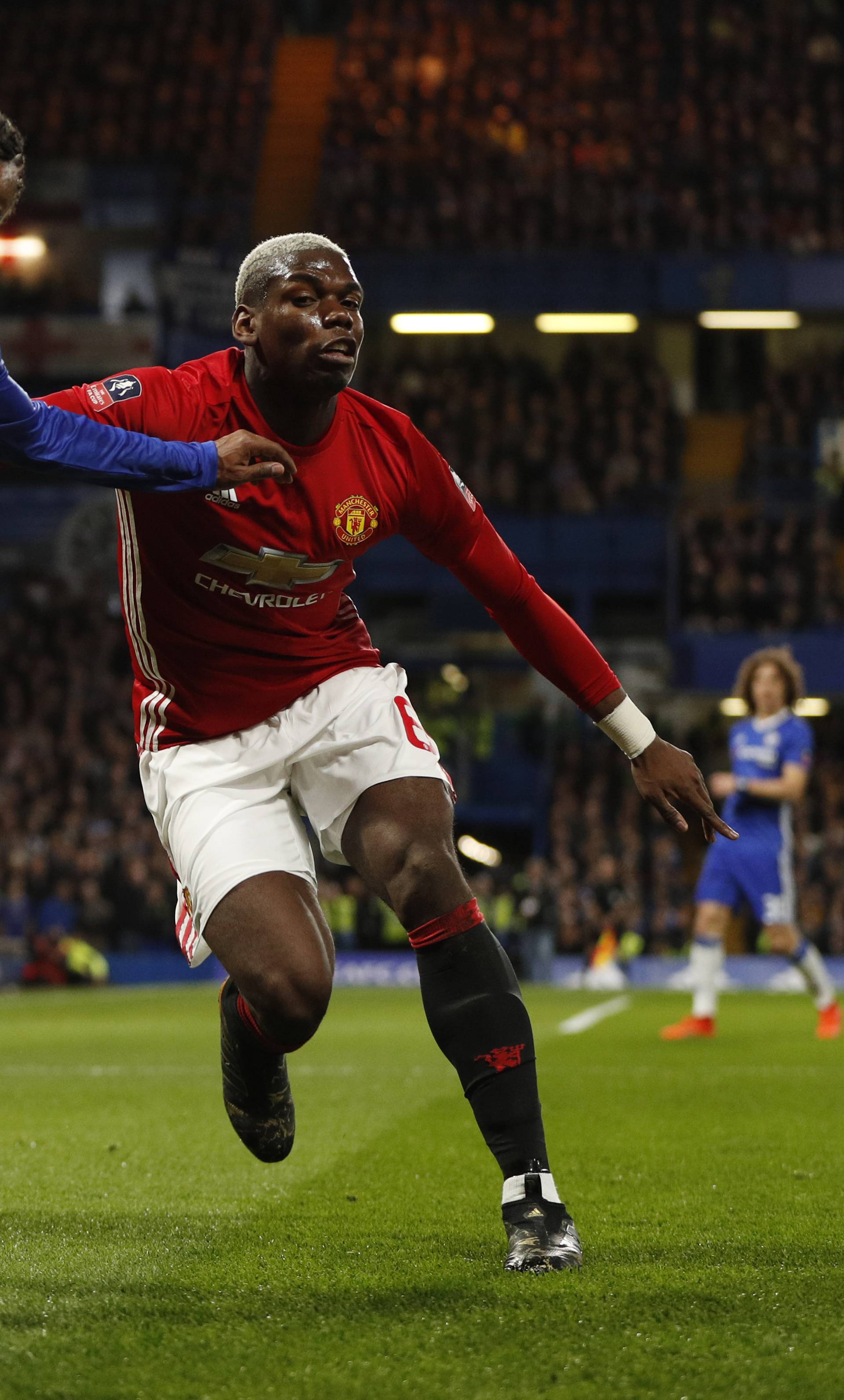 Manchester United's Paul Pogba in action with Chelsea's Willian